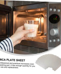 Person placing a glass in a microwave, stack of Six Pack Microwave Mica Sheets Waveguide Cover Heat Resistant Insulation Pads shown.