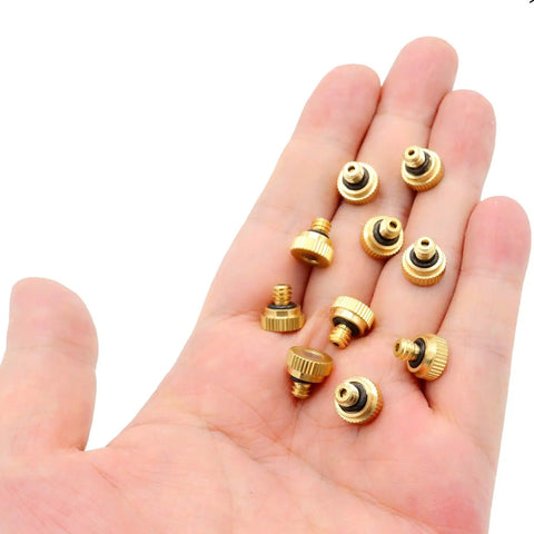 Hand holding Brass Misting Nozzle Replacement Heads 0.2mm Orifice 10/24 UNC Outdoor Cooling System, 10 Pack