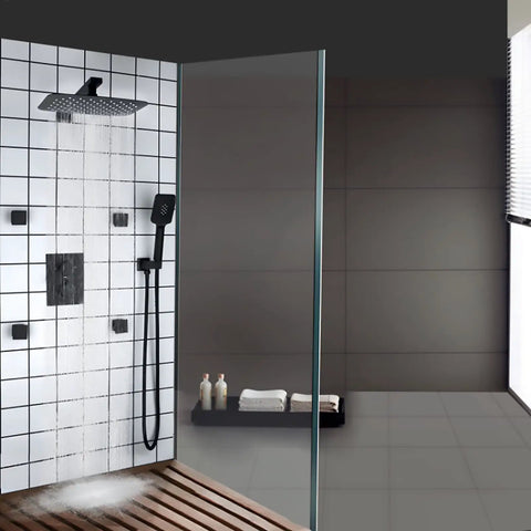 Heavy Duty Black Shower System With 12X8 Inch Rainfall Head Wall Mounted Tub And Shower Trim Kit Featuring 3 Mode Handheld Sprayer Rust Resistant Brass Build For Bathrooms, with water flowing from the rainfall head.