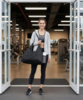 Woman with Women Gym Bag With Yoga Mat Holder And Shoe Compartment, Wet And Dry Storage Pocket, in the gym entrance