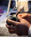 Person using Wool Felt Polishing Wheel Set With Mandrel Handle, 120 Pcs Buffing Wheels For Rotary Tool on sculpture