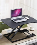 Portable Sit Stand Desk Converter With Heavy Duty Dual Tray Ergonomic Stand on a desk, holding a laptop and mouse.