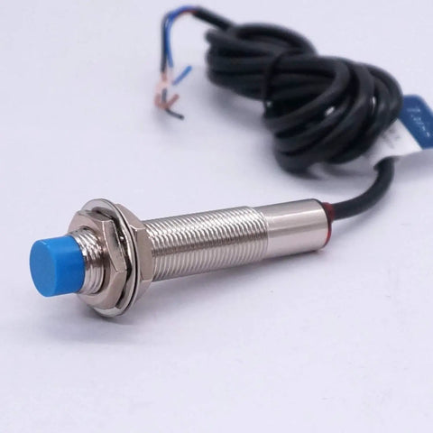Close-up of Must-Have Inductive Proximity Sensor Switch 5V DC NPN Normally Open LJ12A3-4-Z-BX cylinder with blue cap and wires
