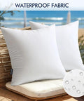 Pack of 2 16x16 Inch Outdoor Pillow Inserts Waterproof Decorative Throw Pillow Forms Square Lumbar Garden Cushions for Patio Sofa Couch Durable 380g High Density Fiber Fill for Plush Comfort on rattan chair near beach.