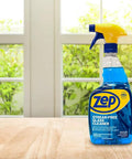 Streak Free Glass Cleaner 32 Oz Pro Grade Formula for Windows and Surfaces in blue bottle on wooden table by window.