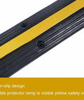 Close-up of Ridiculously Tough Rubber Cable Ramp 1 Channel Cord Cover with yellow non-slip design for safety, holds 22000 lbs