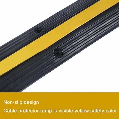 Close-up of Ridiculously Tough Rubber Cable Ramp 1 Channel Cord Cover with yellow non-slip design for safety, holds 22000 lbs