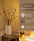 Two Pack Battery Operated LED Willow Branch Lights in vase with soft warm white glow on a wooden table.