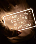 Person holding 'Please Don't Do Coke In The Bathroom LED Neon Sign USB Powered For Bedroom Game Room Bar Or Home Decor 15.8 By 9.8 Inches With 6.6 Ft USB Cord And Dimmer'