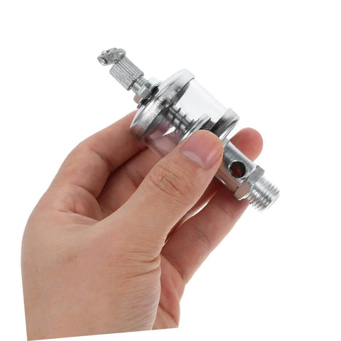 Hand holding a High Pressure Grease Cup Needle Valve, Manual Grease Filling Tool for Fittings and Lathe Machines, pro grade metal part
