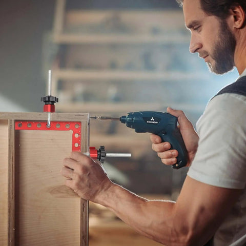 Person using Pro Grade 4 Pack Right Angle Clamp Set For Woodworking, 5.5 Inch Aluminum Alloy Squares With Case for assembling a cabinet.