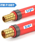 Close-up of two red PEX pipes labeled 1/2" and 3/4" with ASTM F1807 copper fittings for the Angle PEX Crimping Tool Kit For One Half Inch And Three Quarter Inch PEX Rings With Go No Go Gauge And PEX Pipe Cutter Includes Copper Rings Fits US F1807 Standards Pro Grade PEX Plumbing Set