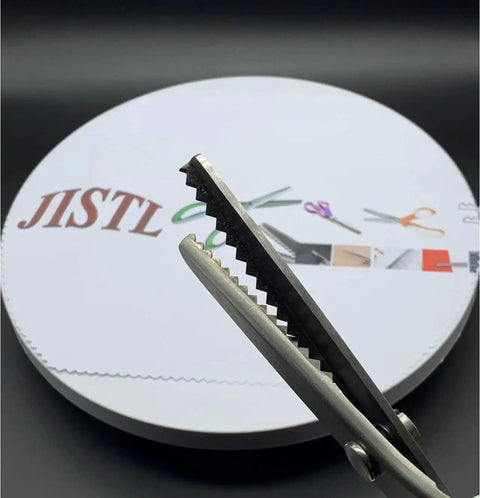 Green Pinking Shears With Comfort Grips For Zigzag Cutting Durable Sewing Scissors close-up of zigzag blades against fabric background