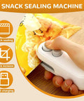 Person using 2 In 1 Rechargeable Bag Sealer With Cutter And Magnet on a snack bag, demonstrating quick sealing, white device