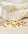Hypoallergenic Flat Back Earrings For Women 14K Gold Plated Mini Stud Set Of 3 Pairs Featuring Star Moon Sun Shapes Flat Back Cartilage Helix Piercing Jewelry Includes 4mm And 5mm Sizes For Daily Mix And Match. 3 gold flat back studs with star, moon and sun charms