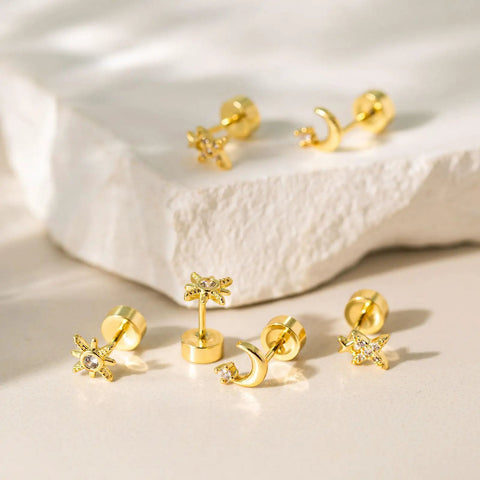 Hypoallergenic Flat Back Earrings For Women 14K Gold Plated Mini Stud Set Of 3 Pairs Featuring Star Moon Sun Shapes Flat Back Cartilage Helix Piercing Jewelry Includes 4mm And 5mm Sizes For Daily Mix And Match. 3 gold flat back studs with star, moon and sun charms