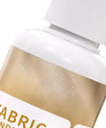 Close-up of waterproof fabric glue with white cap and gold label. Waterproof Fabric Glue For Quick Dry, Clear Clothing Adhesive With Strong Hold, Flexible Textile Repair Solution, Precision Tip Bond For Denim Patches, Craft Fix That Mends Clothes Fast And Keeps It Looking Fresh visible.