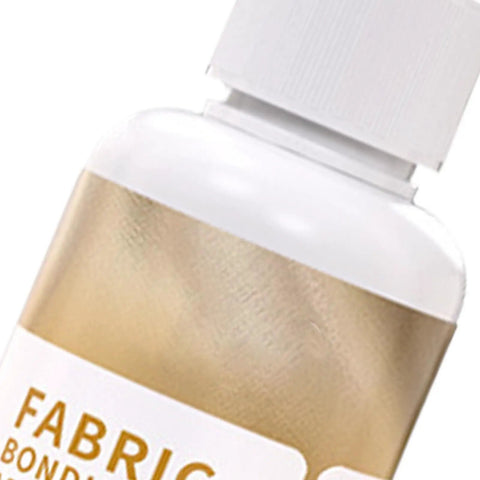 Close-up of waterproof fabric glue with white cap and gold label. Waterproof Fabric Glue For Quick Dry, Clear Clothing Adhesive With Strong Hold, Flexible Textile Repair Solution, Precision Tip Bond For Denim Patches, Craft Fix That Mends Clothes Fast And Keeps It Looking Fresh visible.