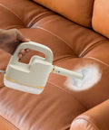 Handheld Steam Cleaner With 6 Speed Adjustable High Temperature And Digital Display 41 Inch Extension Hose 10 Tool Attachments Multi Surface Steamer For Deep Cleaning Home Furniture And Car Boss Level Clean in use on a sofa