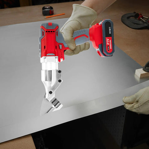 21V Brushless Cordless Sheet Metal Shear With Two Batteries And 360 Degree Pivoting Head cutting stainless steel sheet in a workshop.