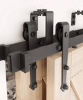 Double Track Bypass Sliding Barn Door Hardware Kit For Two Doors with arrow shaped hangers, side view, installed on light wood panel