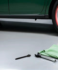 Crankshaft Pulley Removal Tool Gear Puller Kit For Engine Timing Belt And Drive Pulley Disassembly shown next to green car on garage floor