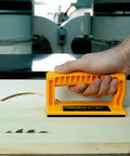Secure Every Cut And Keep Your Knuckles Safe On Table Saws Router Tables Or Band Saws With This Boss 4 Piece Woodworking Kit Featuring A Magnetic Push Stick And Solid Push Blocks, showing an orange push block in use.