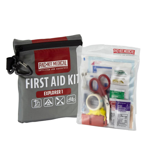 Pac-Kit Medical First Aid Kit Explorer 1 in gray watertight pouch; clear pouch shows scissors and first aid supplies.
