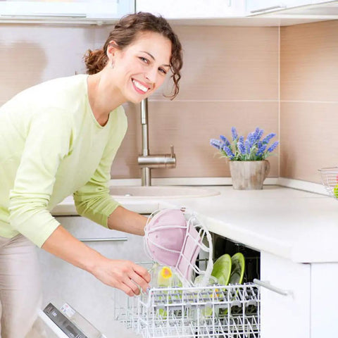 Woman placing pink baseball cap secured in a Three Pack Hat Washer Cage For Washing Machine And Dishwasher Cap Cleaner Frame into dishwasher.