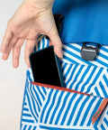 Closeup of a hand placing a phone in the pocket of a Backpack Cooler For 18 Cans With Bottle Opener Leakproof Insulated Cooler Bag