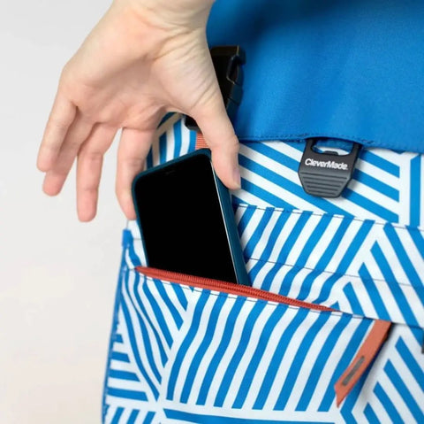 Closeup of a hand placing a phone in the pocket of a Backpack Cooler For 18 Cans With Bottle Opener Leakproof Insulated Cooler Bag