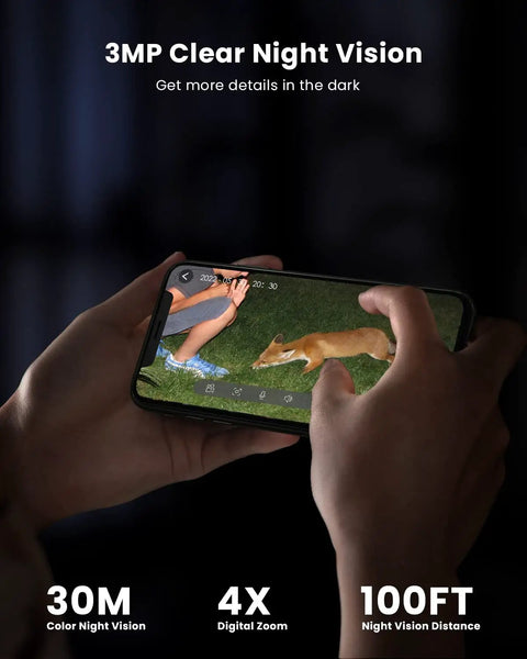 Person holding smartphone displaying live view of Outdoor 2K Wireless Security Camera With Solar Power, night vision mode visible