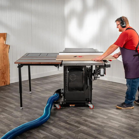 Folding Table Saw Outfeed Kit With Adjustable Height Legs And Foldable Steel Frame in use with woodworker at saw.
