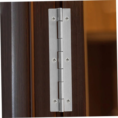 Installed silver continuous piano hinge on dark wood cabinet door with six screws.
