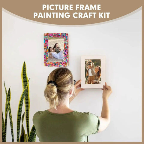 Person hanging Fun DIY Mosaic Photo Frame Kit For 4x6 Photos 8 Unfinished Wooden Frames With Mosaic Tiles And Included Glue Finger Cots And Spreader Tools For Easy Home Craft And Personalized Photo Displays on wall.