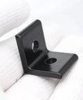 Check Out These 10 pcs Of Heavy Duty Aluminum Extrusion Profiles And Corner Brackets That Are Super Durable And Perfect For Any Wild Project or Cool Build. Black corner bracket held in hand on white background.
