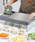 Amazin Goods all-in-one vegetable chopper and prep station, grey with built-in cutting board and clear storage bins