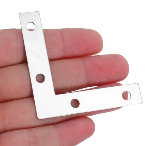 Close-up of L Shape Metal Corner Brackets 100 Pcs 2.17 By 2.17 Inch Silver Iron Frame Supports for DIY projects in hand