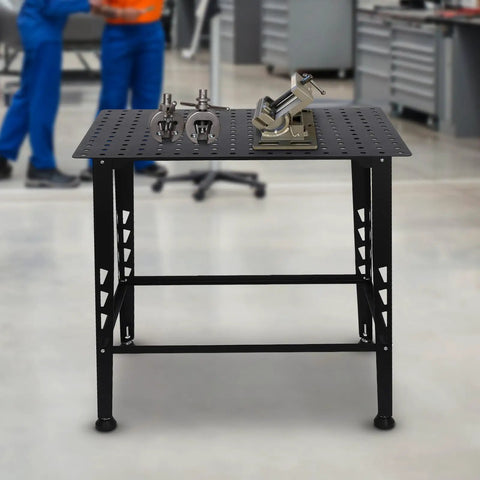 Built Like A Tank Heavy Duty Welding Table 36 By 24 Inches with steel top, clamps, and tools on a sturdy workbench.
