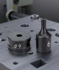Chrome steel dies from 30 Piece Hydraulic Hole Punch Die Set For CH70 And CH70L on metal surface, sizes 9 and 6 visible