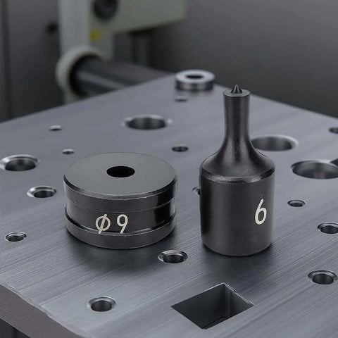 Chrome steel dies from 30 Piece Hydraulic Hole Punch Die Set For CH70 And CH70L on metal surface, sizes 9 and 6 visible