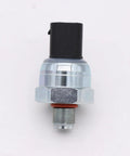 Front view of brake fluid pressure sensor with black rectangular connector, metal body, hex nut, and red seal.