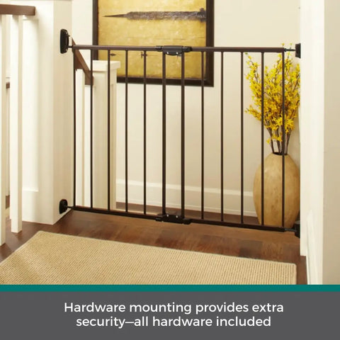 Bulletproof Hardware Mounted Walk Thru Pet Gate 31 Inches Tall Fits 28 To 48 Inch Doorways Displays A Slick Matte Bronze Finish, mounted at a stairway for safety.