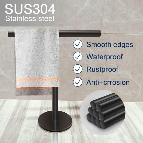 Hand Towel Holder Stand For Bathroom Vanity Countertop Matte Black Finish Free Standing Design Space Saving Movable T Shape Towel Bar Rack For Kitchen And Bath with towel displayed on tile surface.