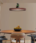 Mid Century Modern Pendant Light 15.8 Inch Wood Grain Finish Dimmable Led Island Lamp with green and black accents above dining table.