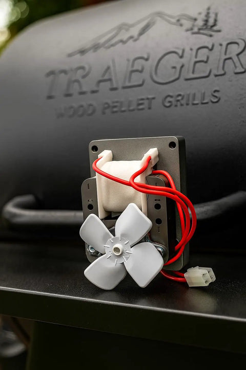 Upgraded Heavy Duty Auger Motor For Pellet Grills Plug And Play Quick Install With Shear Pin And Nut Includes One Year Warranty Silver Finish No Sweat Operation Totally Reliable mounted on Traeger grill.
