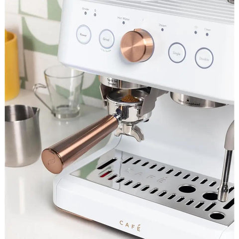 Next Level Semi Automatic Espresso Machine With Badass Built In Grinder And Silky Milk Frother Featuring WiFi App Control Custom Drinks 15 Bar Pump 95 Oz Water Tank Matte White Copper Accents close-up of portafilter, gauge, and copper accents