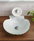 Upgrade Your Bath Game With This Killer Shell Tempered Glass Vessel Sink and Waterfall Faucet Featuring Hot Cold Rotary Mixer Tap Heavy Duty Countertop Wash Basin Smooth Durable Build - Top view of shell-shaped glass sink with waterfall faucet.