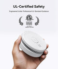 Hassle Free Smoke Detector Designed With Adaptive Sensing To Slash Nuisance Alerts While Delivering Dependable Household Fire Protection Runs Smooth On A Single Nine Volt Battery Offers Quick Easy Wall Install held in hand.