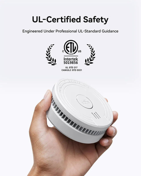 Hassle Free Smoke Detector Designed With Adaptive Sensing To Slash Nuisance Alerts While Delivering Dependable Household Fire Protection Runs Smooth On A Single Nine Volt Battery Offers Quick Easy Wall Install held in hand.
